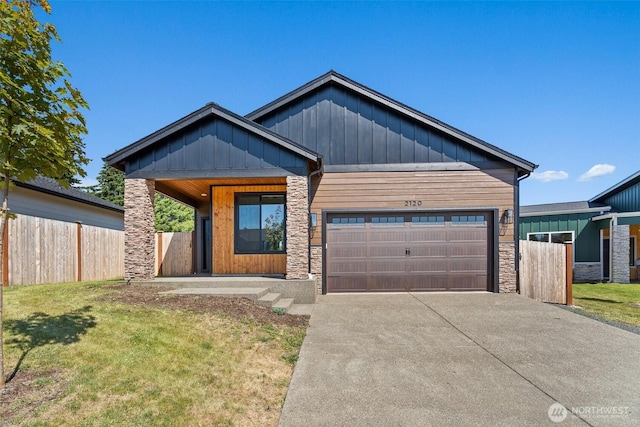 2120 Hawks View Ln, Winlock, WA 98596 - view of front of home with stone siding, a garage, board and batten siding, and concrete driveway