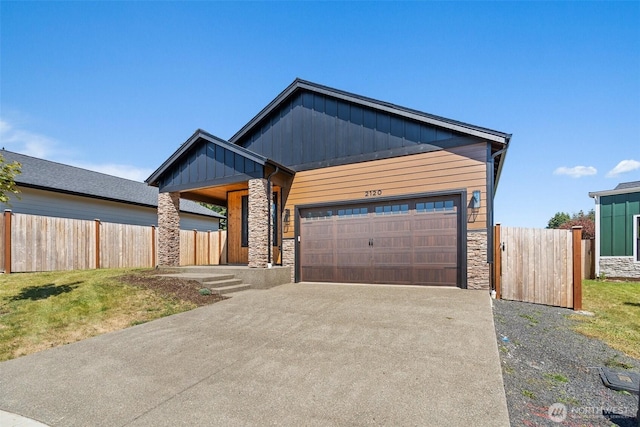 2120 Hawks View Ln, Winlock, WA 98596 - view of front of home featuring stone siding, board and batten siding, an attached garage, and driveway