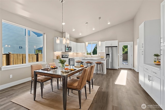 2120 Hawks View Ln, Winlock, WA 98596 - dining area with baseboards, wood finished floors, recessed lighting, and high vaulted ceiling
