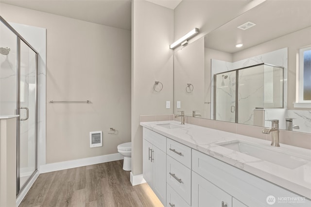 2120 Hawks View Ln, Winlock, WA 98596 - bathroom featuring toilet, double vanity, wood finished floors, and a marble finish shower