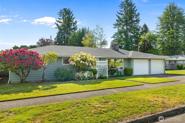702 Cushing St SW, Olympia, WA 98502 - single story home with a garage, a chimney, asphalt driveway, and a front lawn