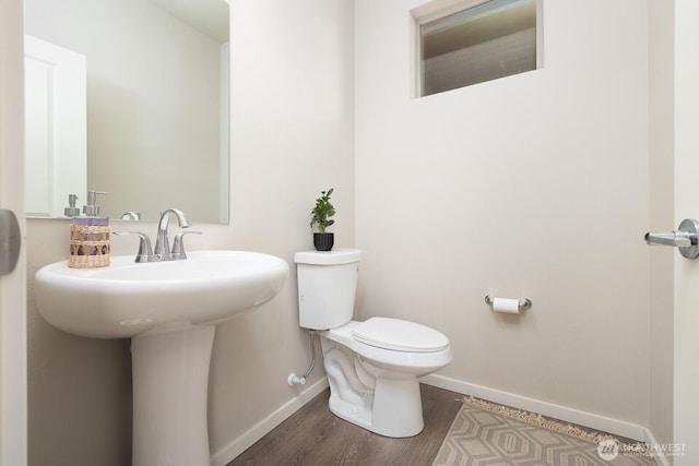 8223 31st Street Ct E, Edgewood, WA 98371 - half bathroom with baseboards, toilet, wood finished floors, and a sink