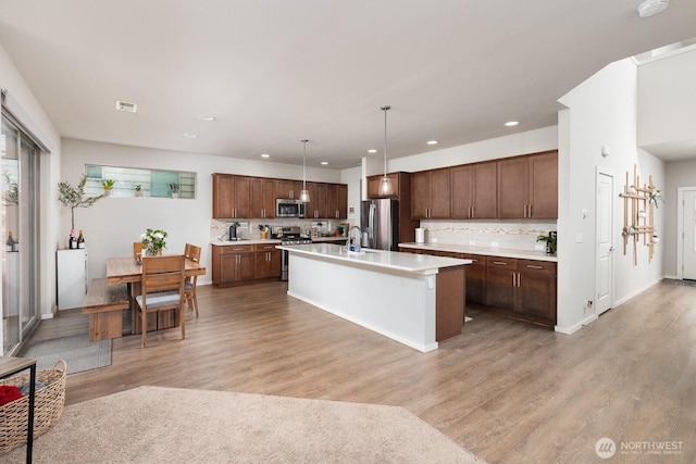 8223 31st Street Ct E, Edgewood, WA 98371 - kitchen with stainless steel appliances, a sink, recessed lighting, light countertops, and light wood-style floors