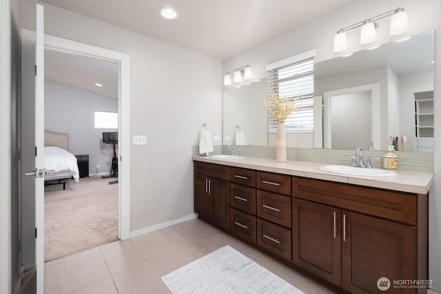 8223 31st Street Ct E, Edgewood, WA 98371 - ensuite bathroom with double vanity, tile patterned flooring, decorative backsplash, baseboards, and recessed lighting