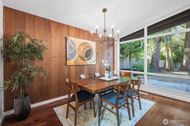 2342 N 120th St, Seattle, WA 98133 - dining area with a chandelier, wooden walls, wood finished floors, and baseboards
