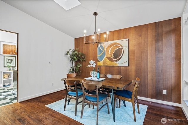 2342 N 120th St, Seattle, WA 98133 - dining space featuring a chandelier, wood finished floors, a skylight, vaulted ceiling, and baseboards