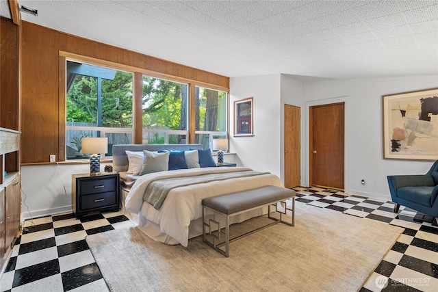 2342 N 120th St, Seattle, WA 98133 - bedroom featuring tile patterned floors, two closets, and wood walls