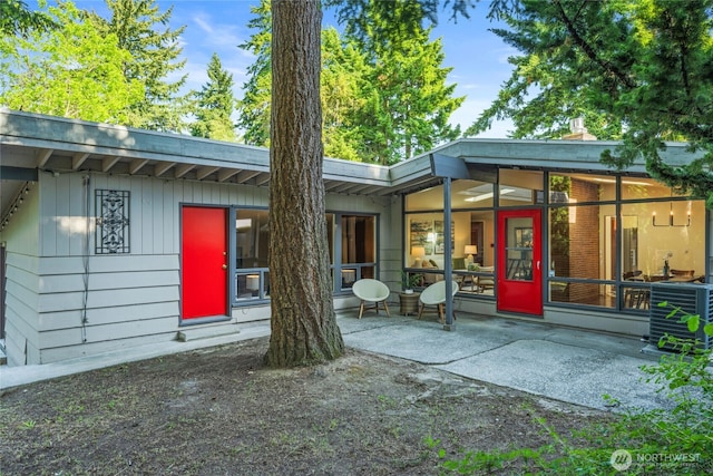 2342 N 120th St, Seattle, WA 98133 - back of house featuring central air condition unit, a patio, and a sunroom