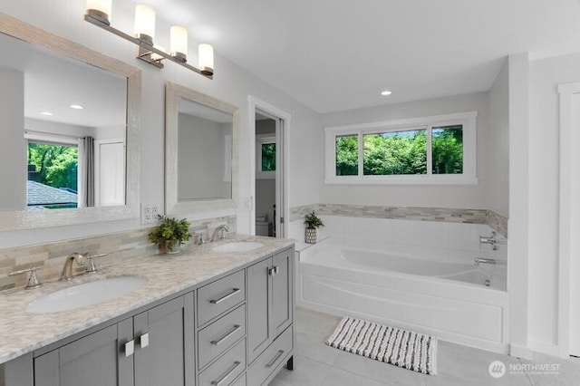 711 NW 120th St, Seattle, WA 98177 - full bath featuring plenty of natural light, tile patterned floors, a bath, double vanity, and recessed lighting