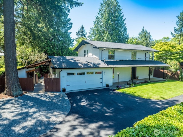 711 NW 120th St, Seattle, WA 98177 - view of front of house with asphalt driveway, an attached garage, a shingled roof, and covered porch