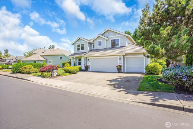 7118 Ashdown Ln SE, Olympia, WA 98513 - view of front of property featuring board and batten siding, driveway, an attached garage, and a tiled roof