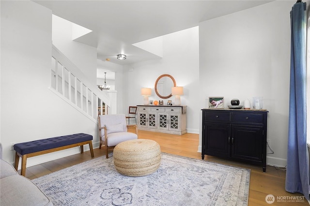 7118 Ashdown Ln SE, Olympia, WA 98513 - living area featuring stairway, wood finished floors, a chandelier, and baseboards