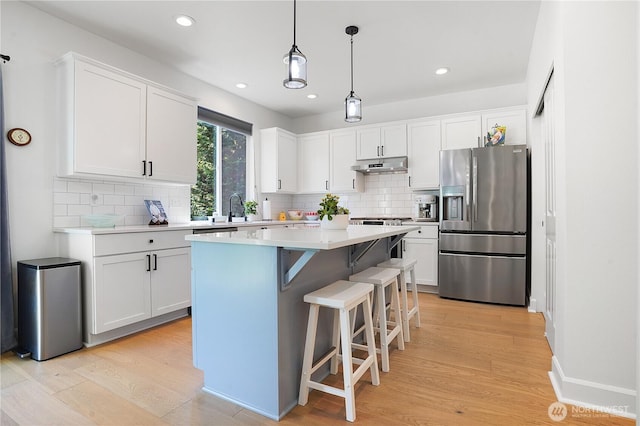 7118 Ashdown Ln SE, Olympia, WA 98513 - kitchen featuring stainless steel refrigerator with ice dispenser, under cabinet range hood, white cabinets, light countertops, and recessed lighting