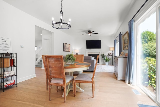 7118 Ashdown Ln SE, Olympia, WA 98513 - dining room with ceiling fan, plenty of natural light, light wood-style flooring, and a chandelier