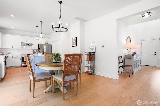 7118 Ashdown Ln SE, Olympia, WA 98513 - dining room featuring a chandelier, light wood finished floors, recessed lighting, and baseboards