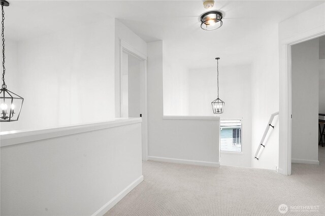 7118 Ashdown Ln SE, Olympia, WA 98513 - hallway with a chandelier, an upstairs landing, carpet, and baseboards