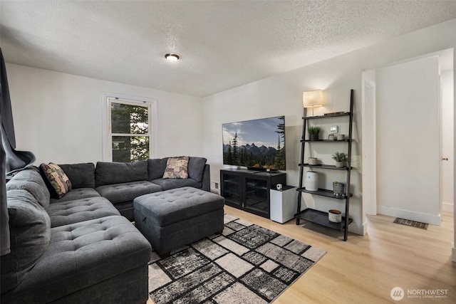 1704 27th Ave, Seattle, WA 98122 - living area with a textured ceiling and light wood finished floors