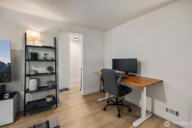 1704 27th Ave, Seattle, WA 98122 - office area with wood finished floors, baseboards, and a textured ceiling