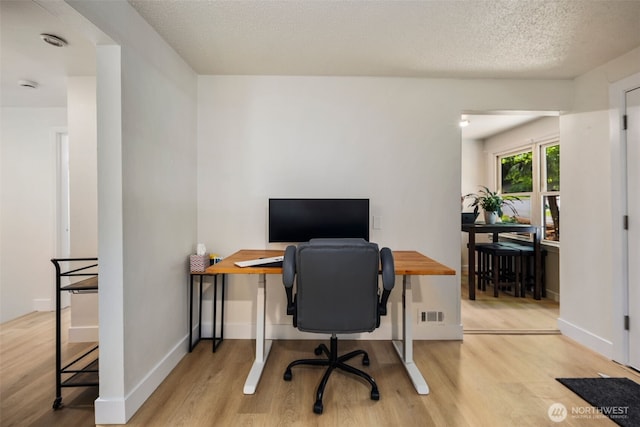 1704 27th Ave, Seattle, WA 98122 - office area featuring wood finished floors, baseboards, and a textured ceiling