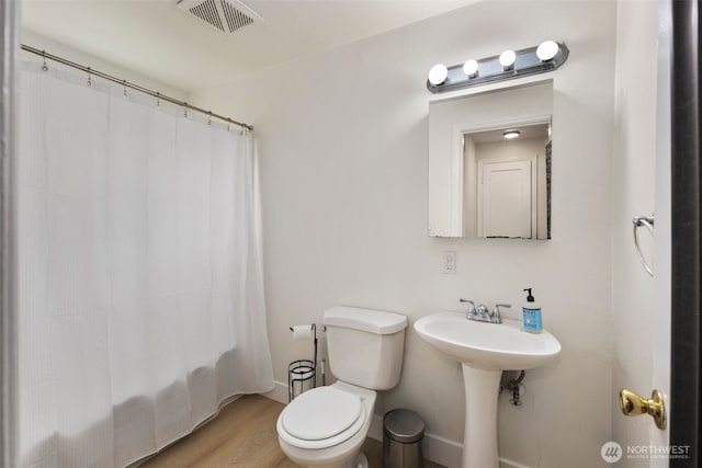 1704 27th Ave, Seattle, WA 98122 - bathroom with toilet, wood finished floors, a shower with curtain, a sink, and baseboards