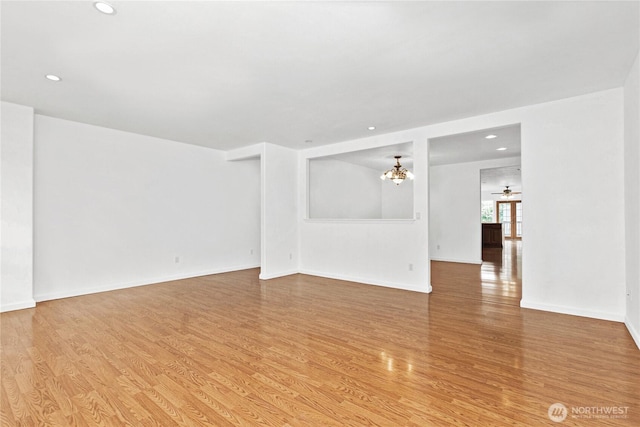 514 Mckinley Ave, Raymond, WA 98577 - spare room with wood finished floors, a chandelier, recessed lighting, and baseboards