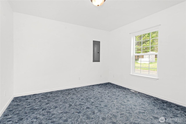 514 Mckinley Ave, Raymond, WA 98577 - spare room featuring electric panel, dark carpet, and baseboards