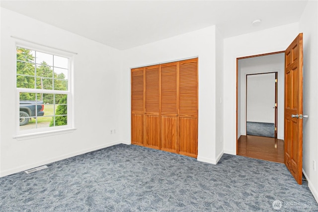 514 Mckinley Ave, Raymond, WA 98577 - unfurnished bedroom with carpet flooring, a closet, and baseboards