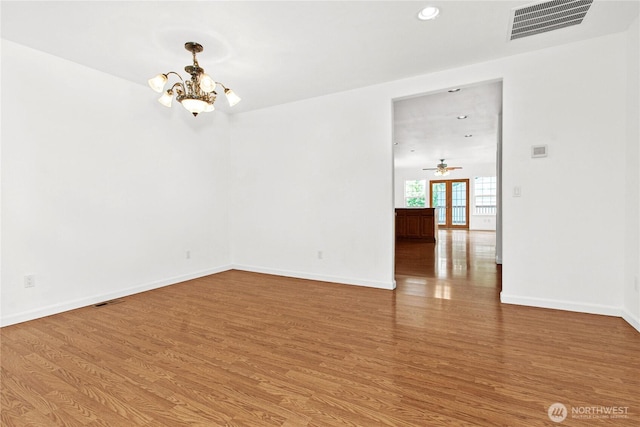 514 Mckinley Ave, Raymond, WA 98577 - spare room featuring a chandelier, wood finished floors, baseboards, and recessed lighting