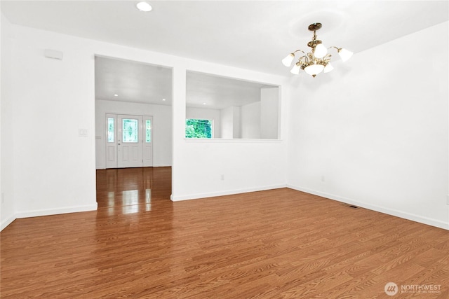 514 Mckinley Ave, Raymond, WA 98577 - spare room featuring a chandelier, wood finished floors, baseboards, and recessed lighting