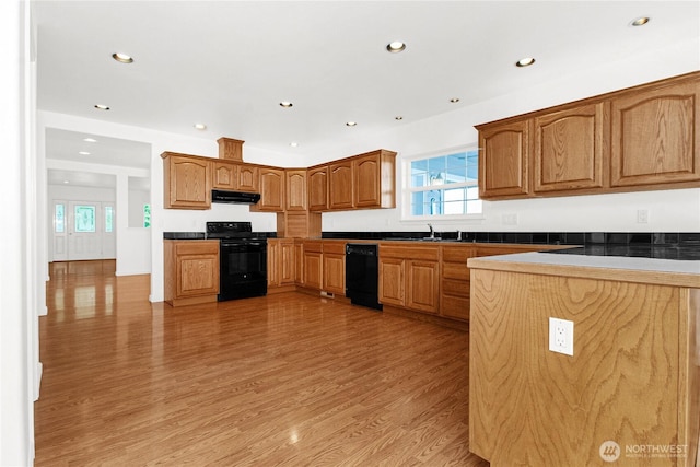 514 Mckinley Ave, Raymond, WA 98577 - kitchen featuring black appliances, range hood, light wood-style floors, a sink, and recessed lighting