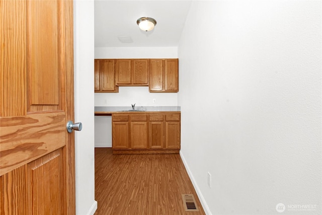 514 Mckinley Ave, Raymond, WA 98577 - corridor with wood finished floors, baseboards, and a sink