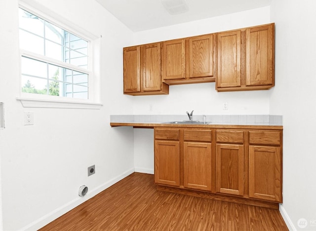 514 Mckinley Ave, Raymond, WA 98577 - kitchen with a sink, dark wood-style floors, and brown cabinetry