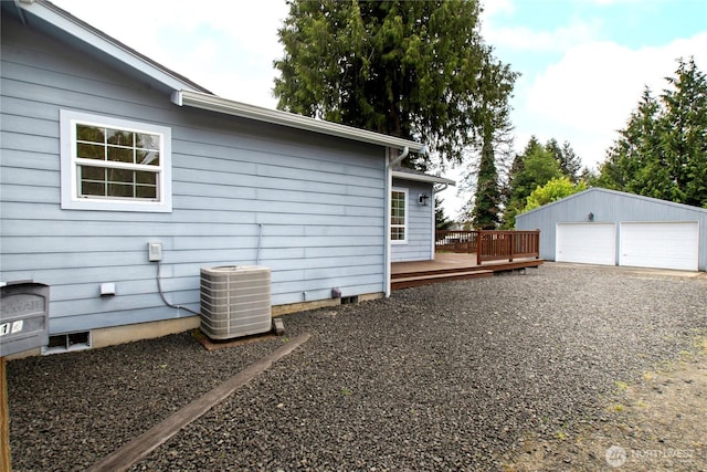 514 Mckinley Ave, Raymond, WA 98577 - view of property exterior with central air condition unit, a deck, a detached garage, and an outdoor structure