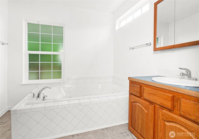 514 Mckinley Ave, Raymond, WA 98577 - full bathroom featuring vanity, a jetted tub, and tile patterned flooring