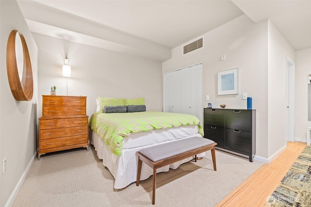 17 W Mercer St Unit 206, Seattle, WA 98119 - bedroom featuring a closet, baseboards, and light wood finished floors