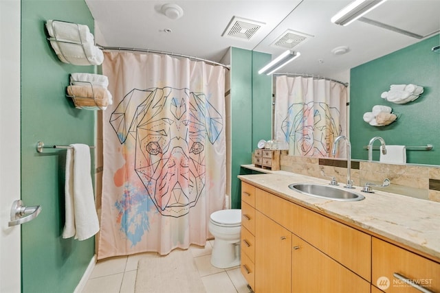 17 W Mercer St Unit 206, Seattle, WA 98119 - full bathroom featuring toilet, vanity, tile patterned flooring, and a shower with curtain