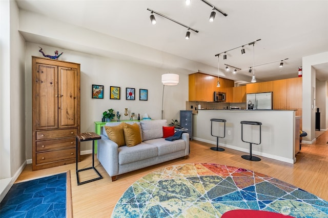 17 W Mercer St Unit 206, Seattle, WA 98119 - living room featuring light wood finished floors and rail lighting