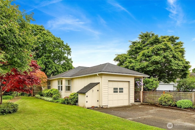 2708 Lynn St, Bellingham, WA 98225 - view of front facade with driveway, an outdoor structure, a garage, and a shingled roof