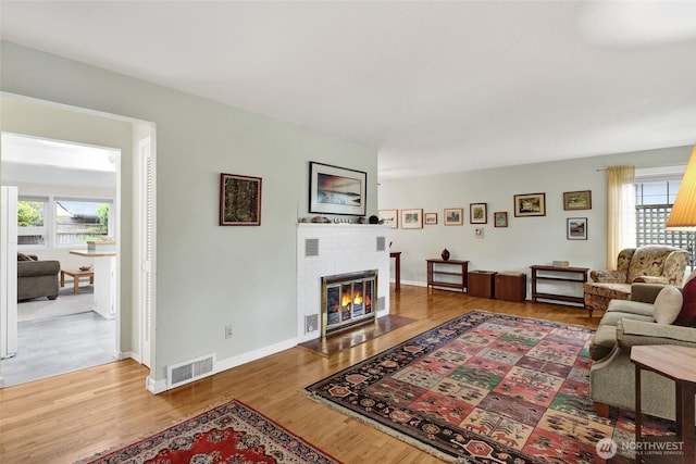 2708 Lynn St, Bellingham, WA 98225 - living room featuring healthy amount of natural light, a fireplace, wood finished floors, and baseboards