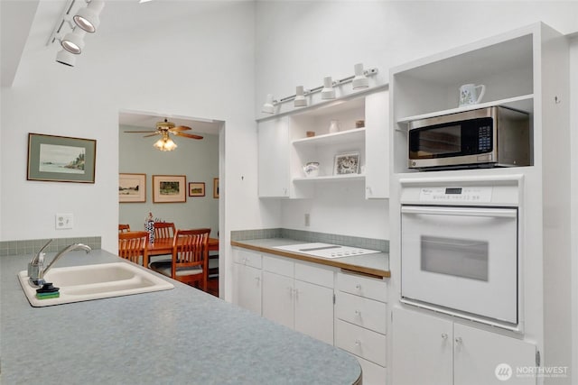 2708 Lynn St, Bellingham, WA 98225 - kitchen featuring white appliances, a sink, open shelves, track lighting, and white cabinetry