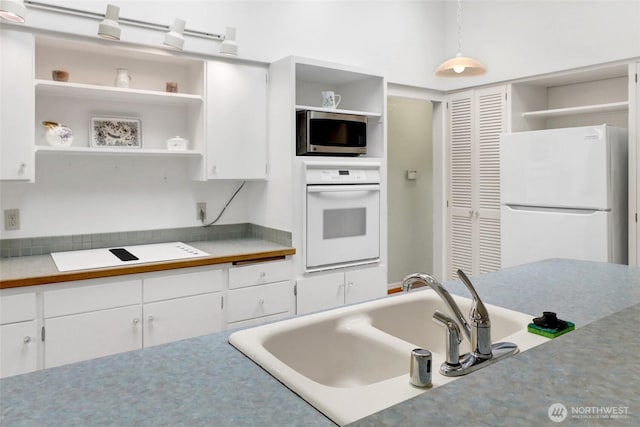 2708 Lynn St, Bellingham, WA 98225 - kitchen with white appliances, open shelves, white cabinetry, a sink, and light countertops