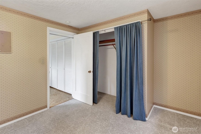 2708 Lynn St, Bellingham, WA 98225 - unfurnished bedroom featuring ornamental molding, carpet, a textured ceiling, and wallpapered walls