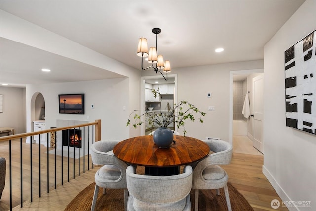 200 James St Unit 206, Edmonds, WA 98020 - dining room featuring light wood-type flooring, recessed lighting, baseboards, and a warm lit fireplace