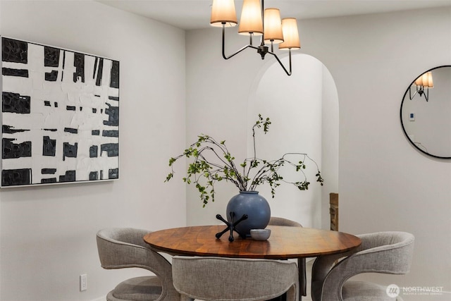 200 James St Unit 206, Edmonds, WA 98020 - dining space with a chandelier, arched walkways, and baseboards