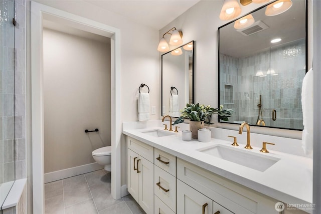 200 James St Unit 206, Edmonds, WA 98020 - full bath with toilet, double vanity, tile patterned flooring, a tile shower, and baseboards