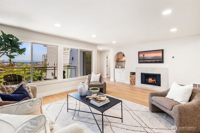 200 James St Unit 206, Edmonds, WA 98020 - living room featuring recessed lighting, a fireplace with flush hearth, light wood-style floors, and baseboards