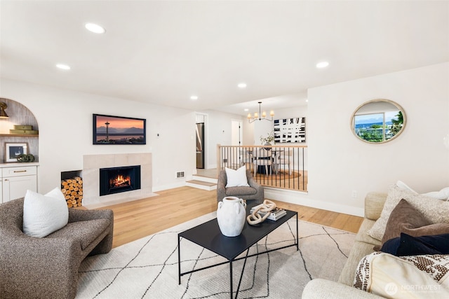200 James St Unit 206, Edmonds, WA 98020 - living room featuring a chandelier, light wood-style floors, a premium fireplace, recessed lighting, and baseboards