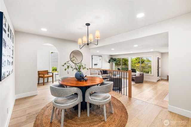 200 James St Unit 206, Edmonds, WA 98020 - dining space with arched walkways, light wood-style floors, recessed lighting, and baseboards