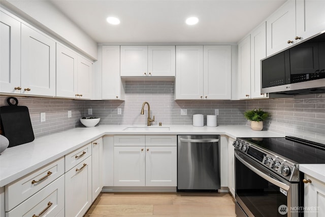200 James St Unit 206, Edmonds, WA 98020 - kitchen featuring appliances with stainless steel finishes, a sink, light countertops, and recessed lighting