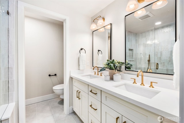 200 James St Unit 206, Edmonds, WA 98020 - full bathroom with toilet, double vanity, tile patterned flooring, tiled shower, and baseboards